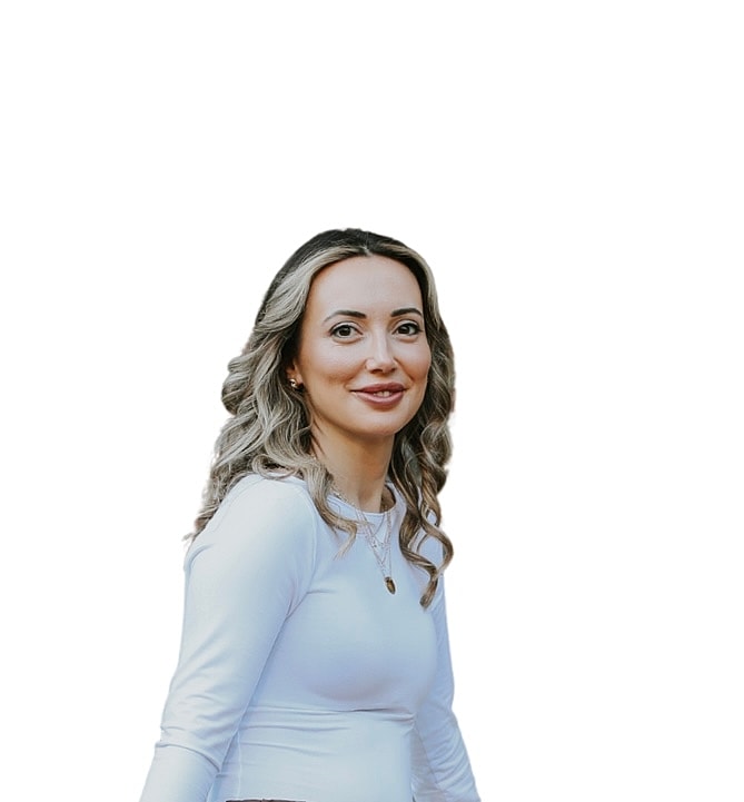 Smiling woman in a white long-sleeve shirt.