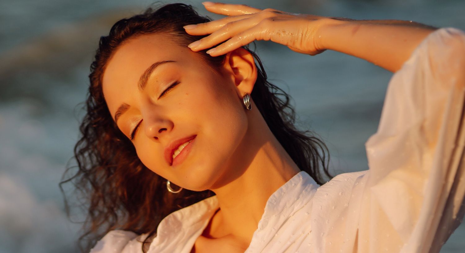 Woman enjoying the sun by the ocean.
